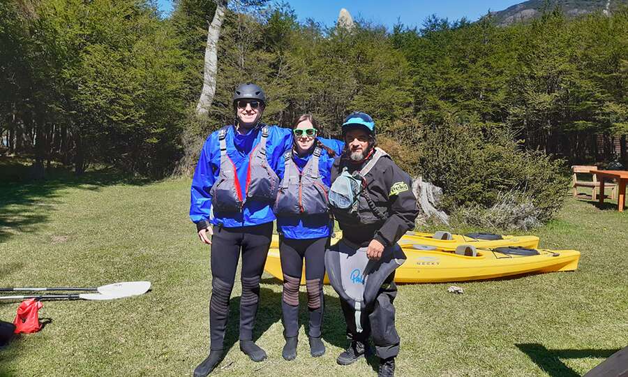 The group geared up next to the kayaks